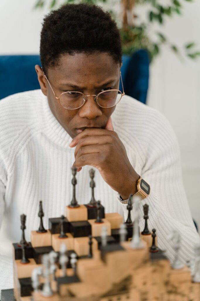 A man deeply focused on a chess game, emphasizing strategy and concentration.