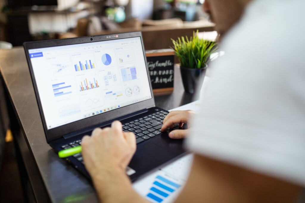 Mastering the First Impression: Your intriguing post title goes here Focused business analysis with charts and graphs on a laptop in a modern office setting.